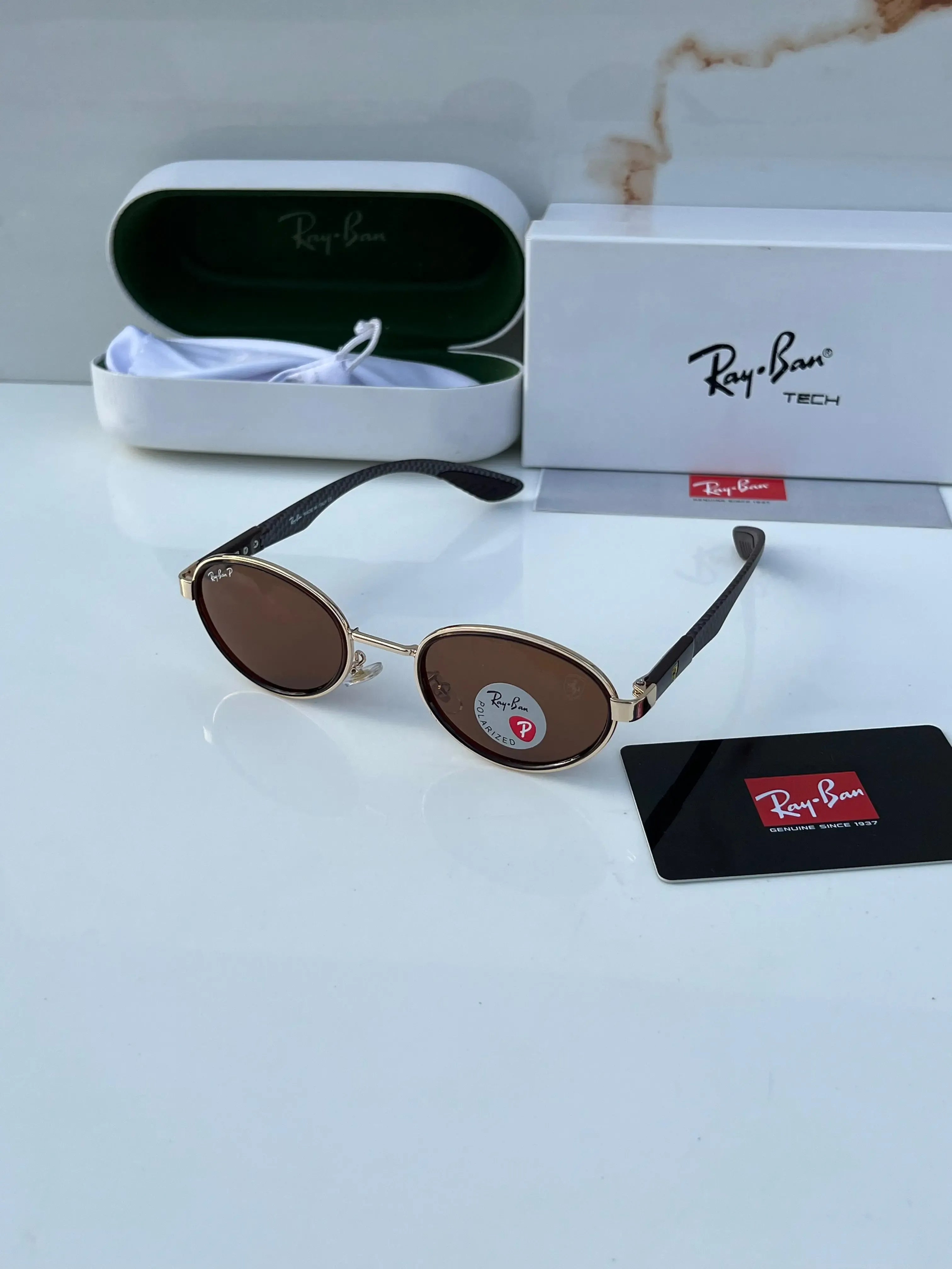 Ray-Ban x Ferrari RB8206 Gold Brown - Hand holding frame showing gold oval rim with polarized brown lenses and Ray-Ban P logo