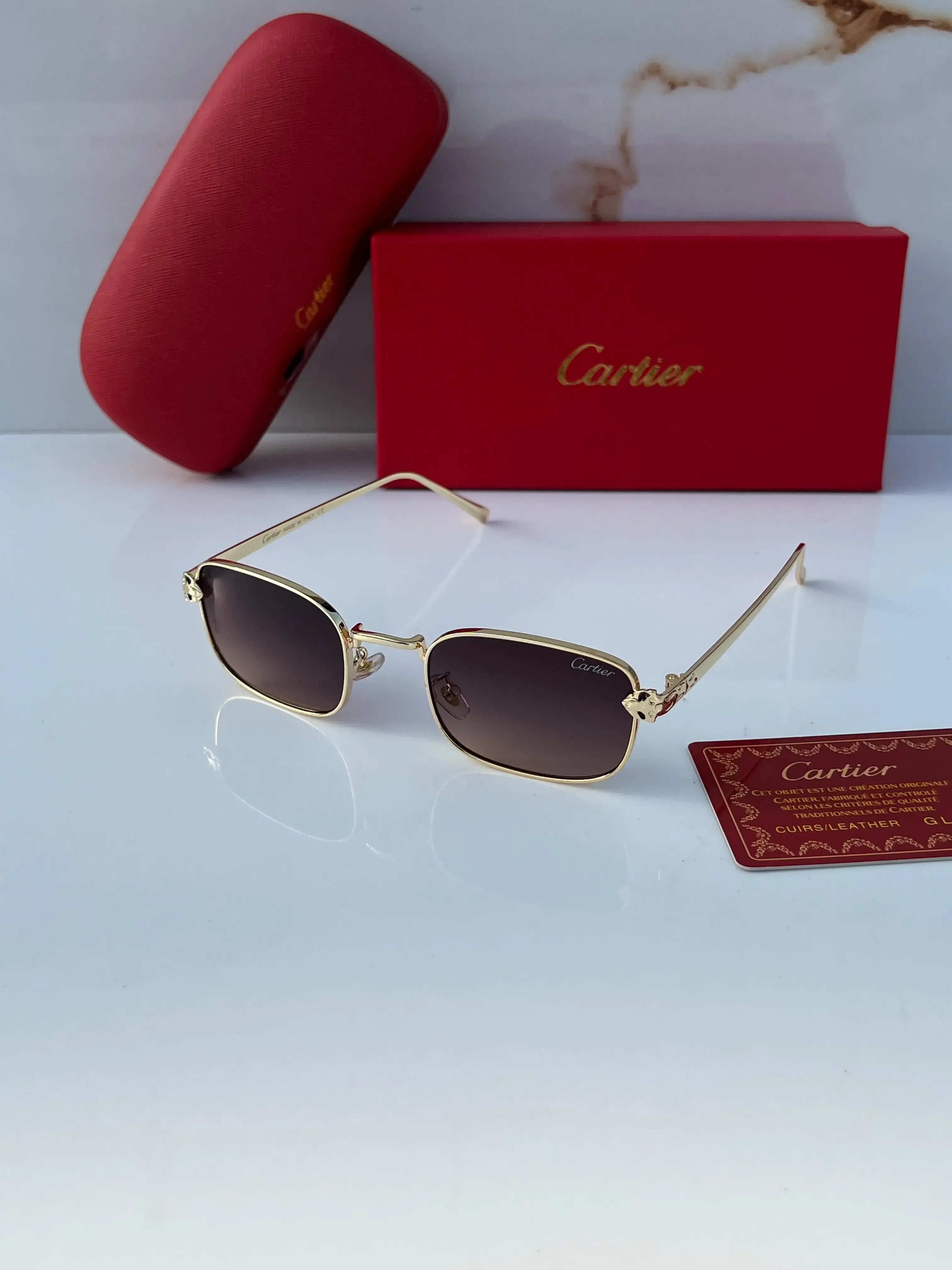 Gold rectangular sunglasses with brown gradient lenses - flat lay with Cartier red box and authenticity card