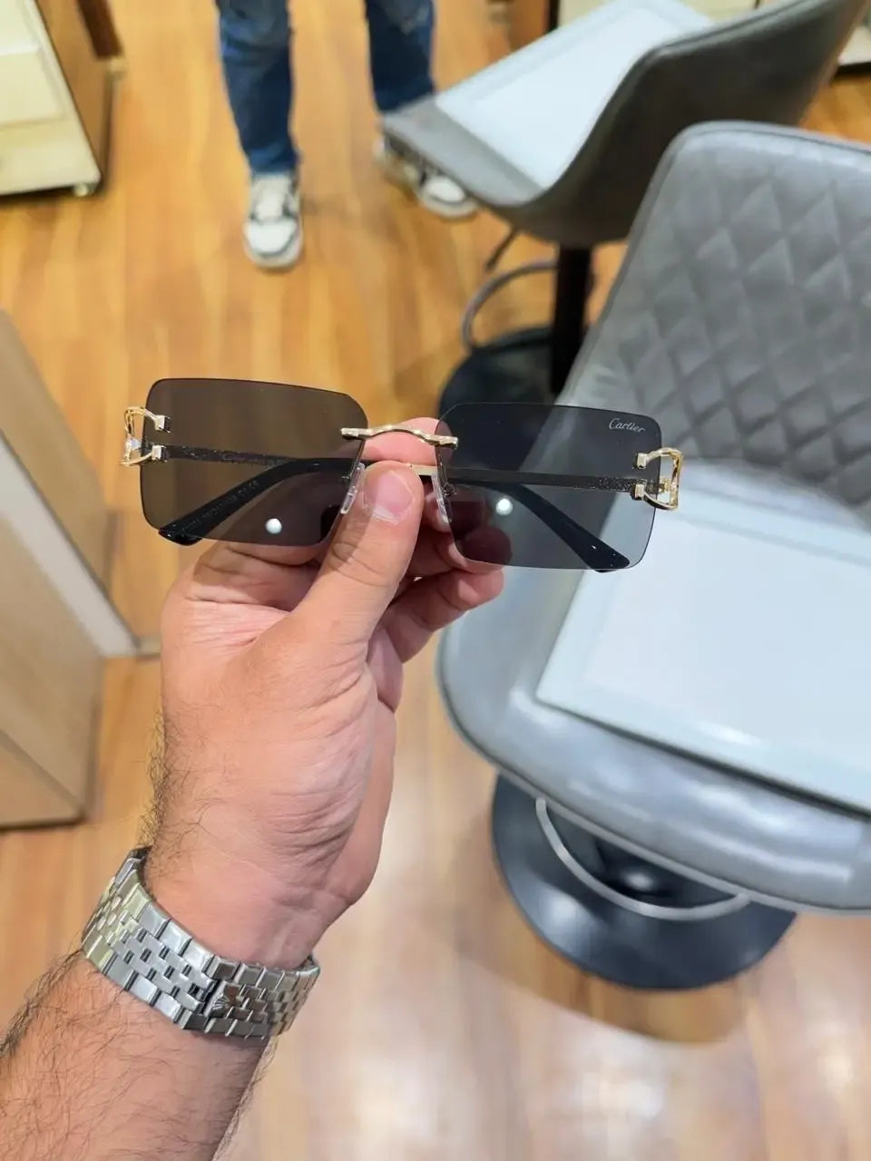 Rimless gold C-frame dual tone sunglasses - folded side view showing brown and grey gradient lenses