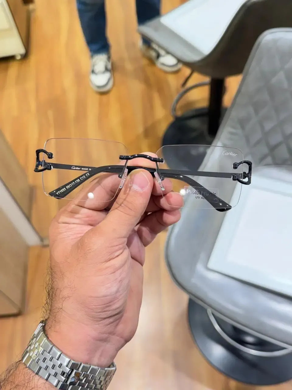 Rimless black C-frame eyeglasses - front view showing clear lenses and bridge