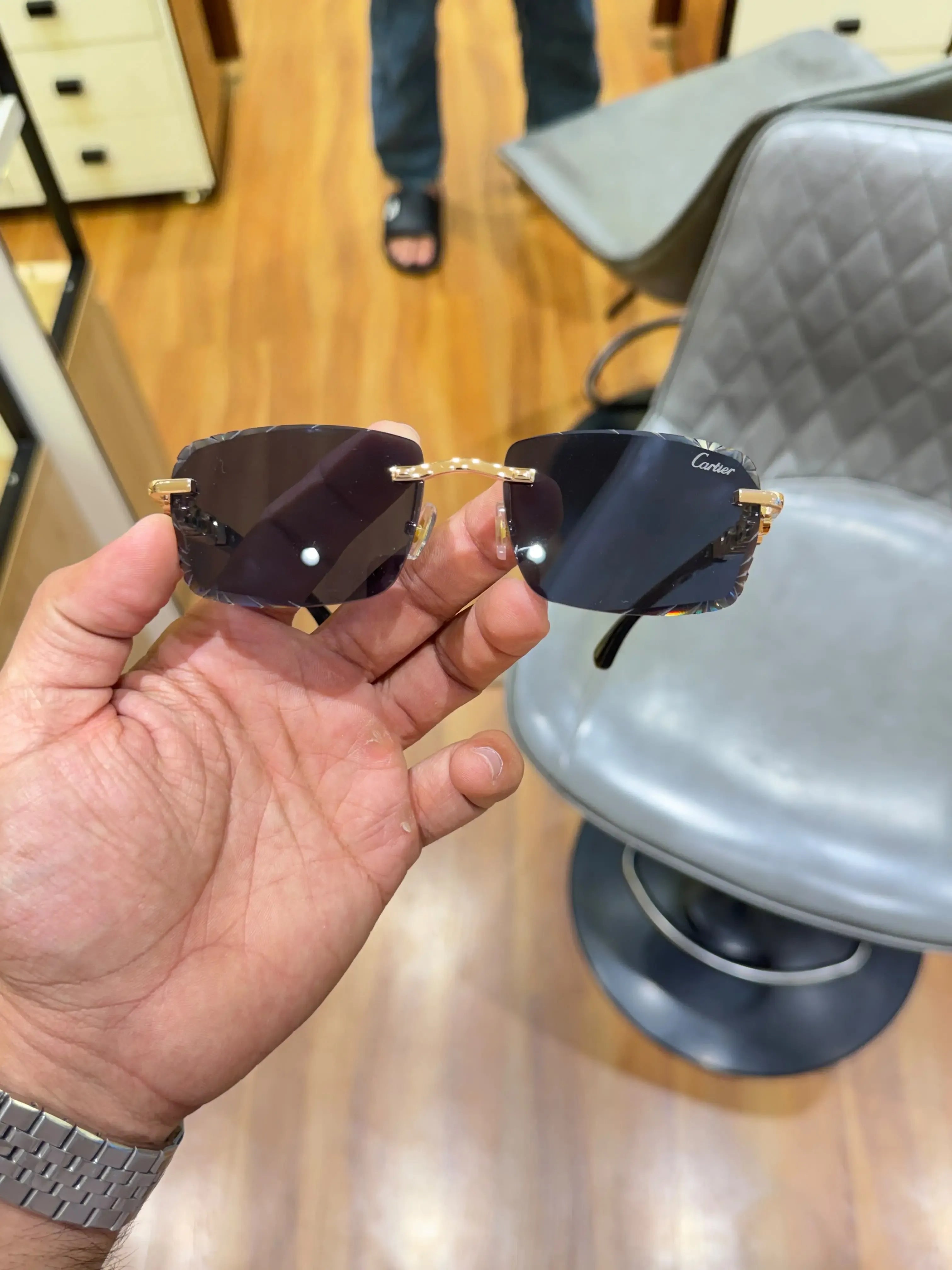 Rimless panther gold sunglasses - temple detail with red gem accents