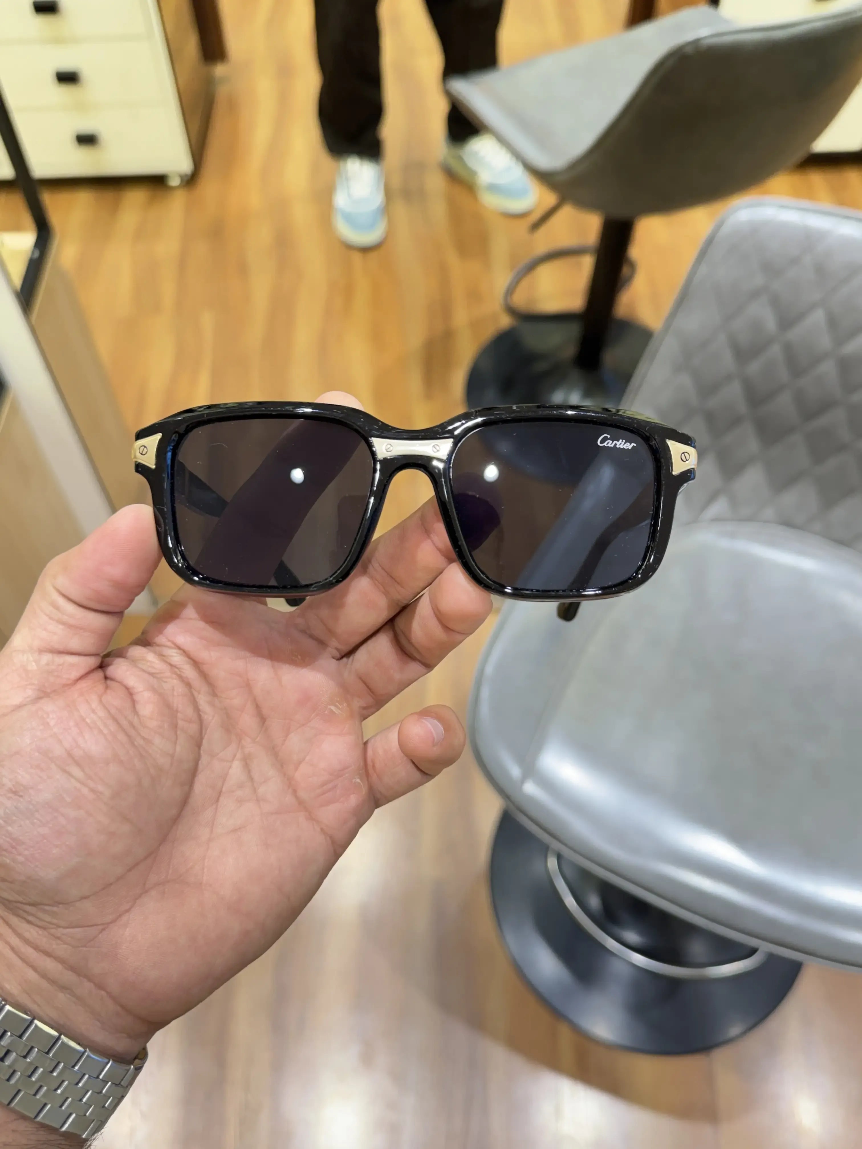Black acetate square sunglasses with gold temple inserts - front view showing dark smoke lenses and Cartier branding