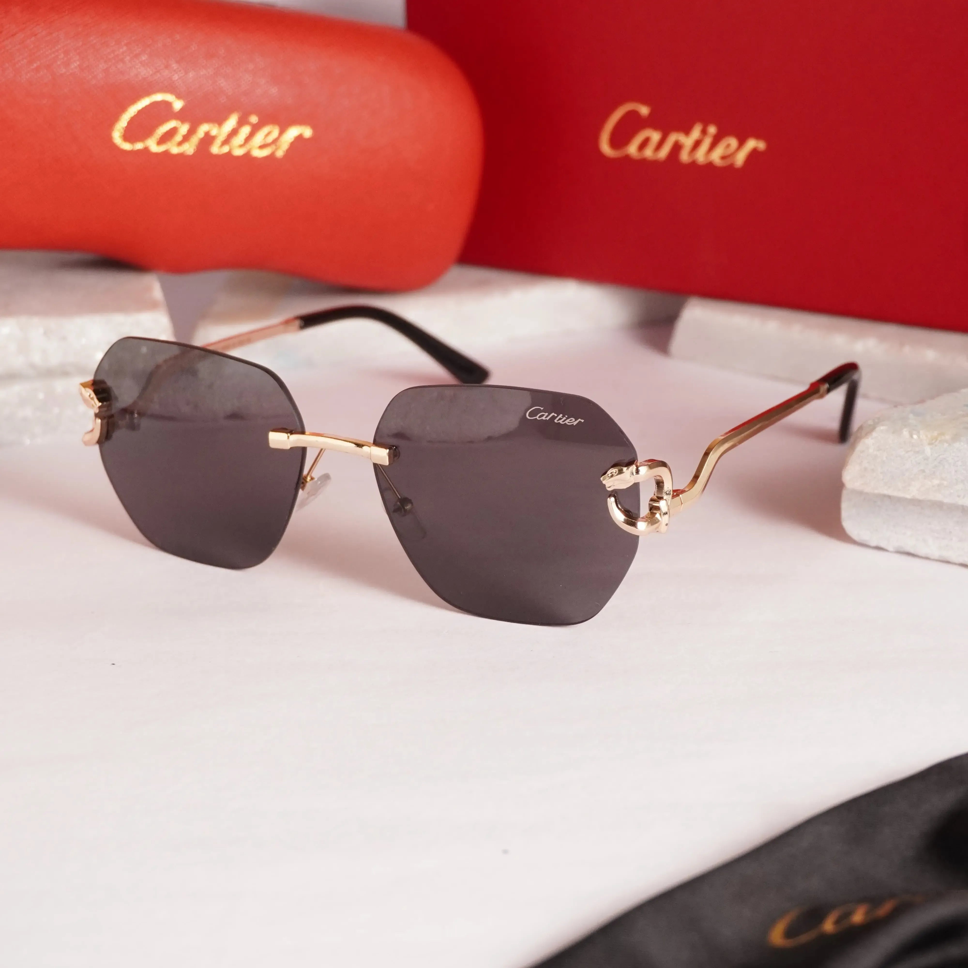Rimless gold panther black sunglasses - front 3/4 view with Cartier red case