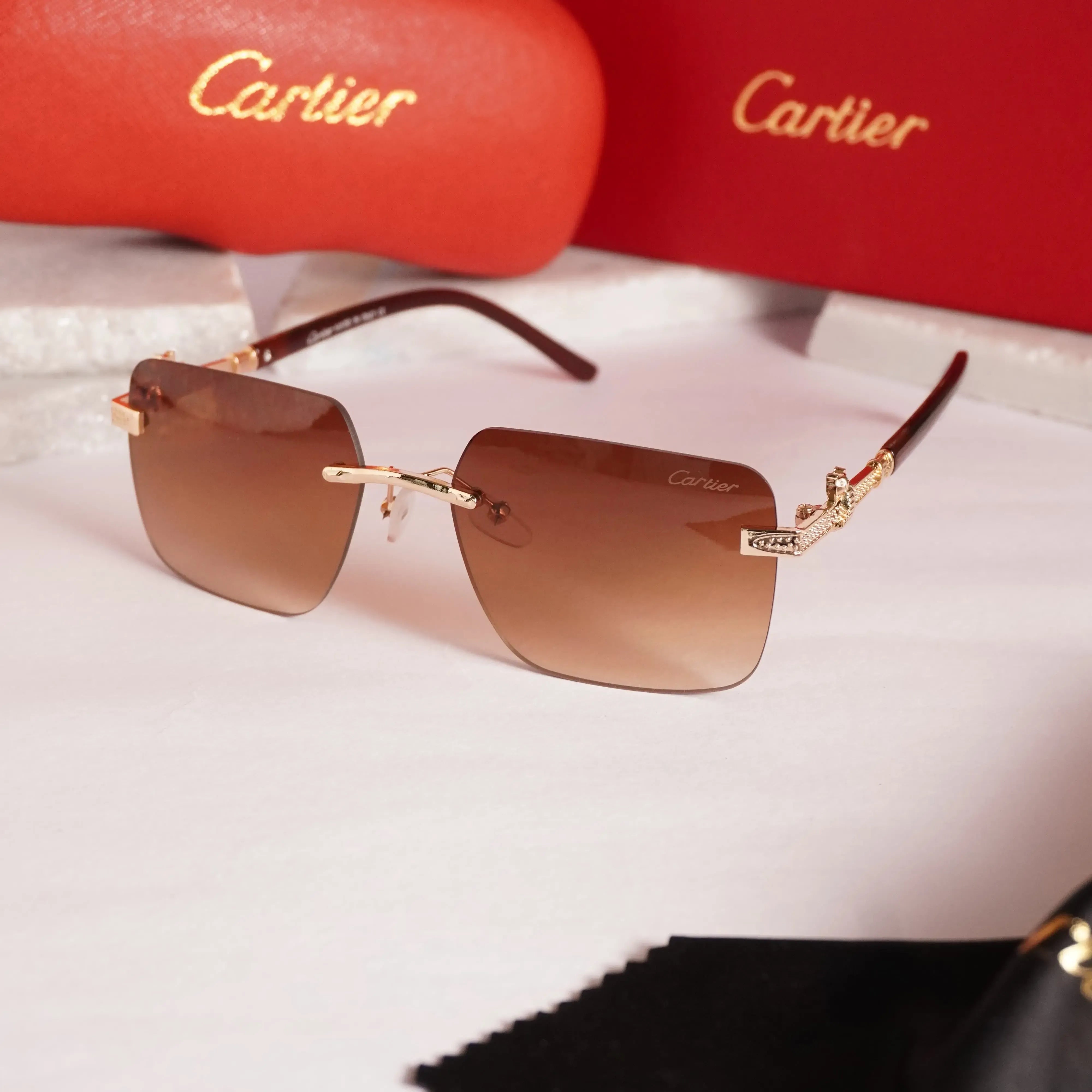 Rimless square gold brown gradient sunglasses - front view with Cartier red case and cleaning cloth