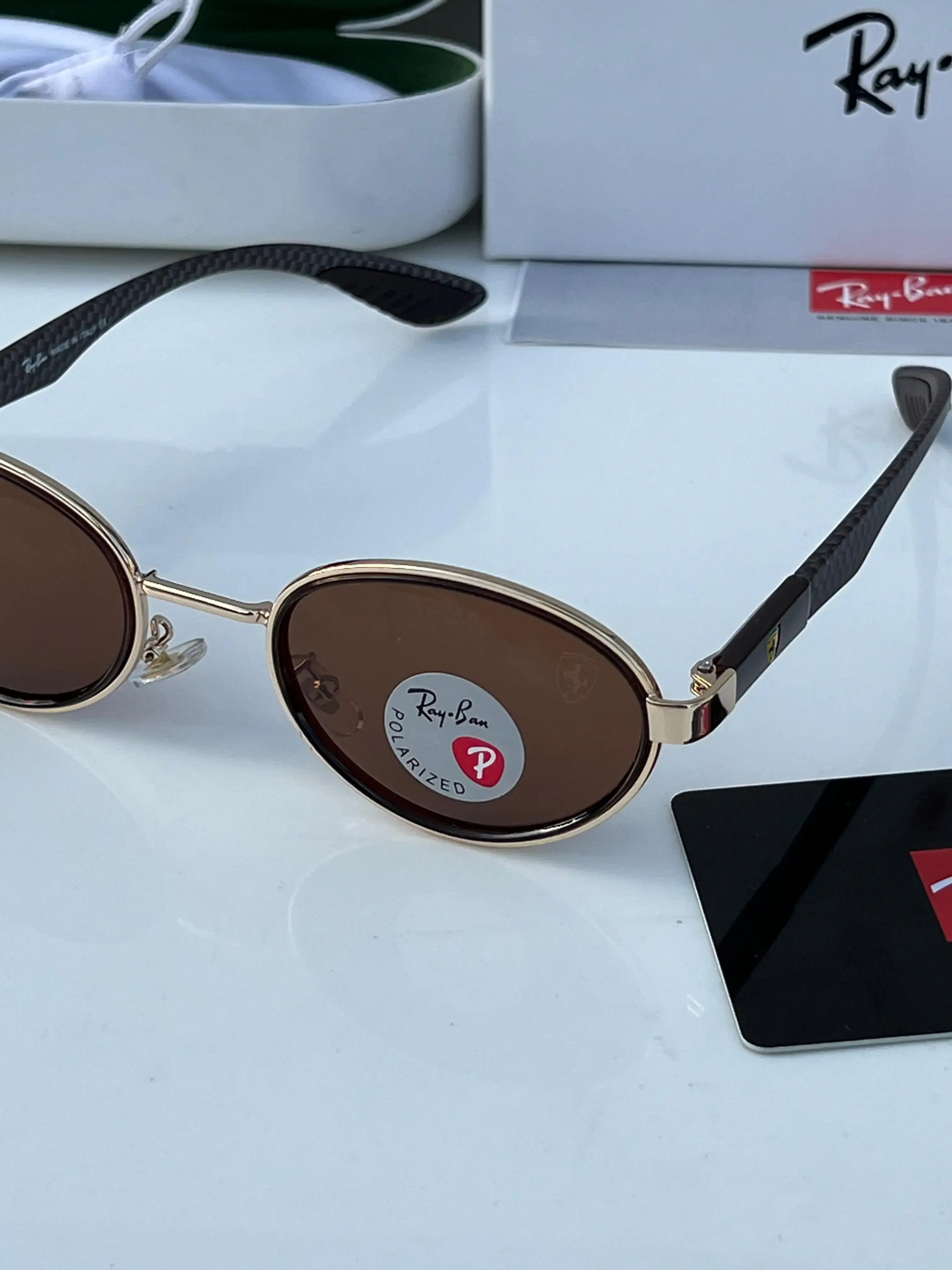 Ray-Ban x Ferrari RB8206 Gold Brown - Flat lay showing frame with Ray-Ban Tech white box and green hard case