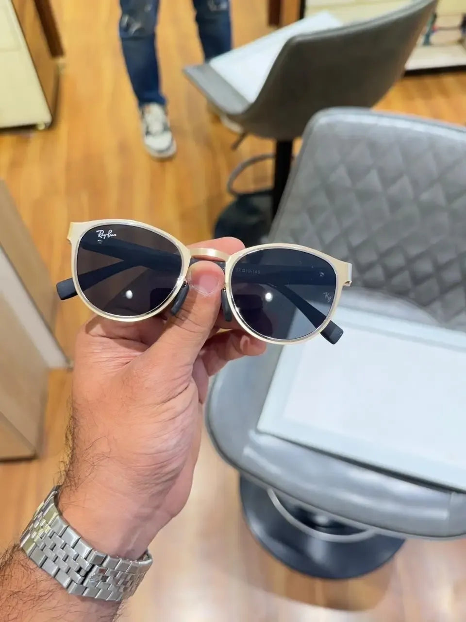 Ray-Ban RB2604 Gold Black - Front palm view showing champagne gold metal frame and dark grey lenses