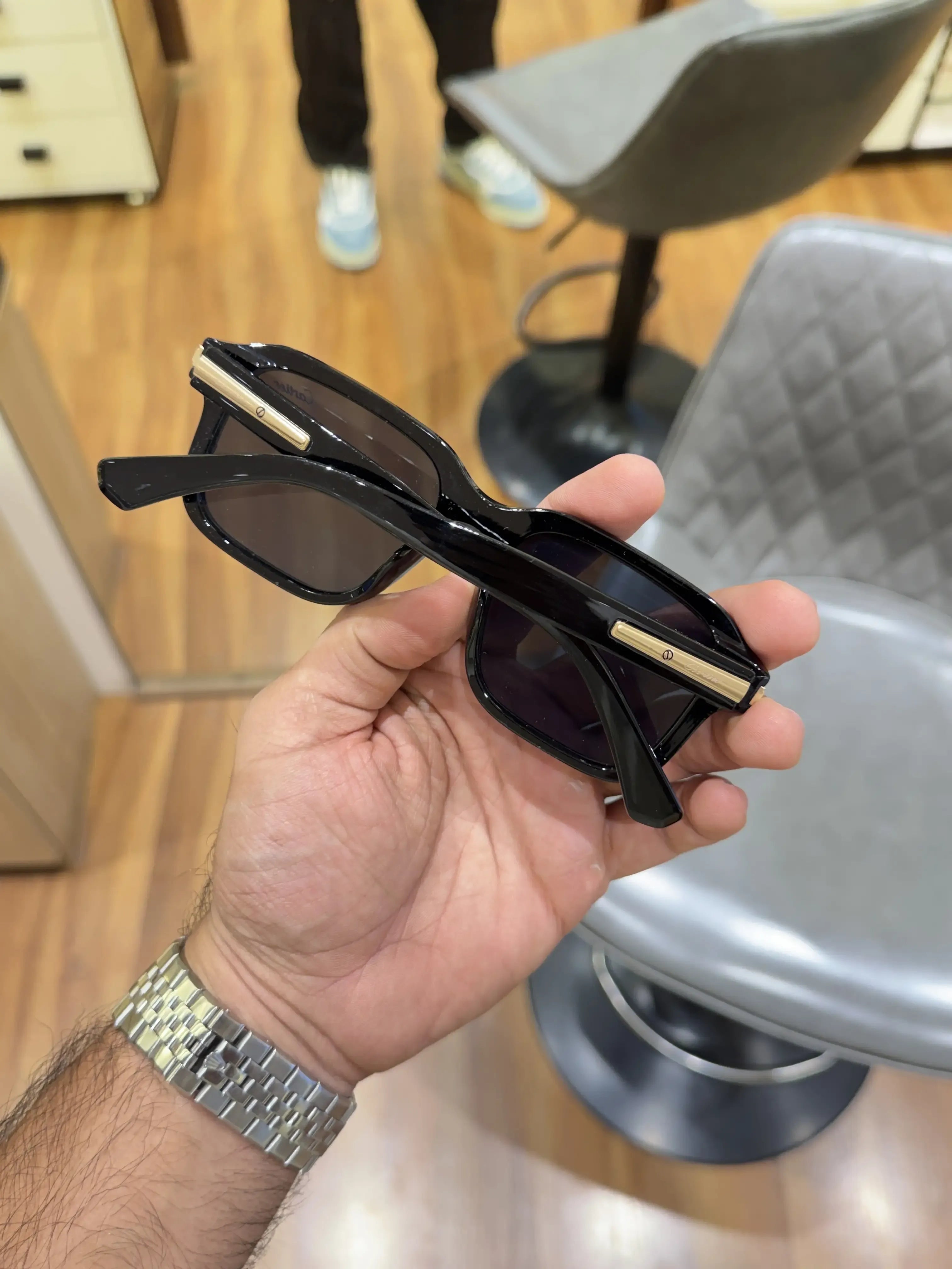 Black acetate square sunglasses with gold temple inserts - folded side view showing gold temple insert detail