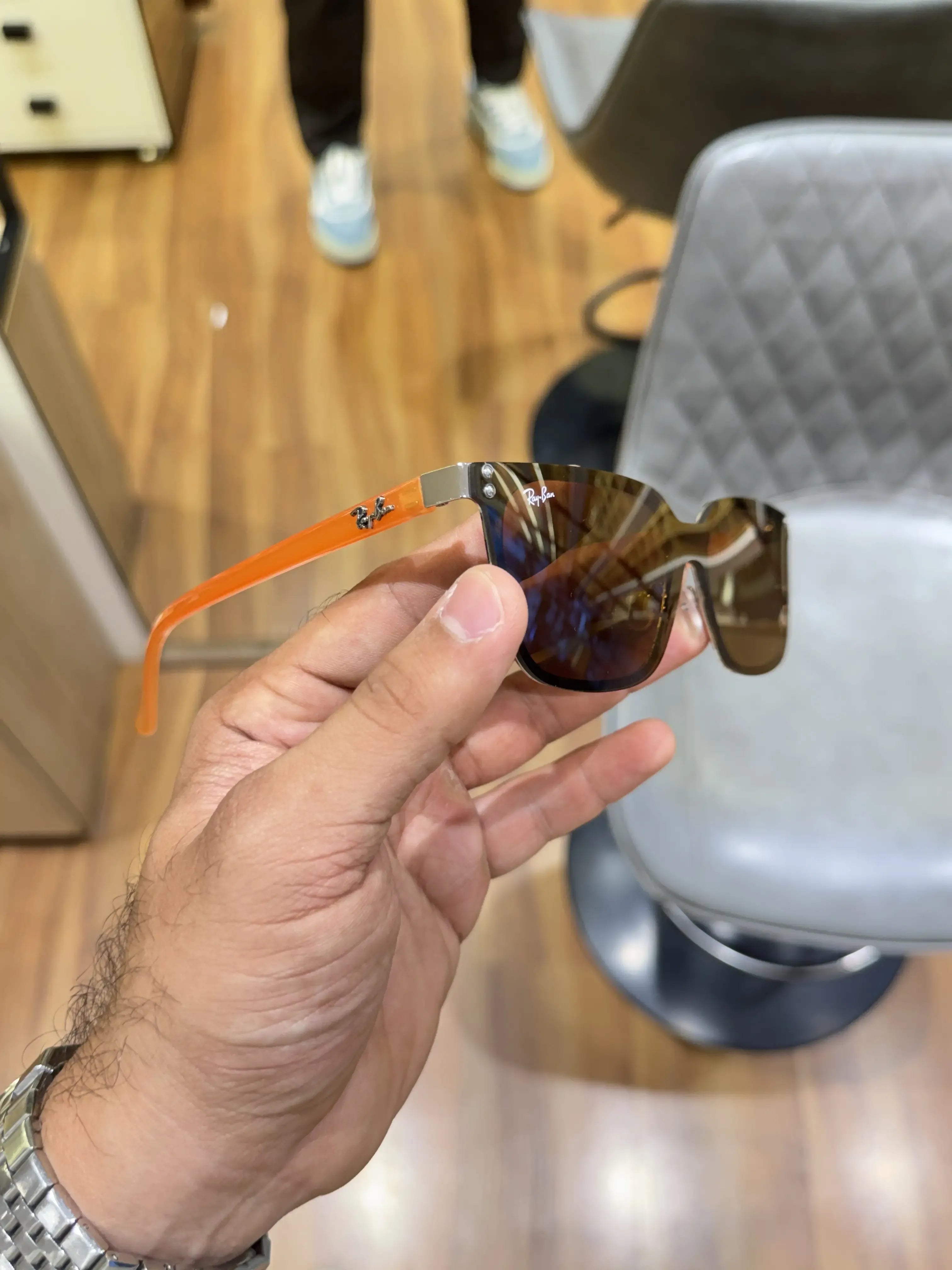Ray-Ban RB2507S Orange Brown - Palm view showing warm brown lenses and dark navy acetate front