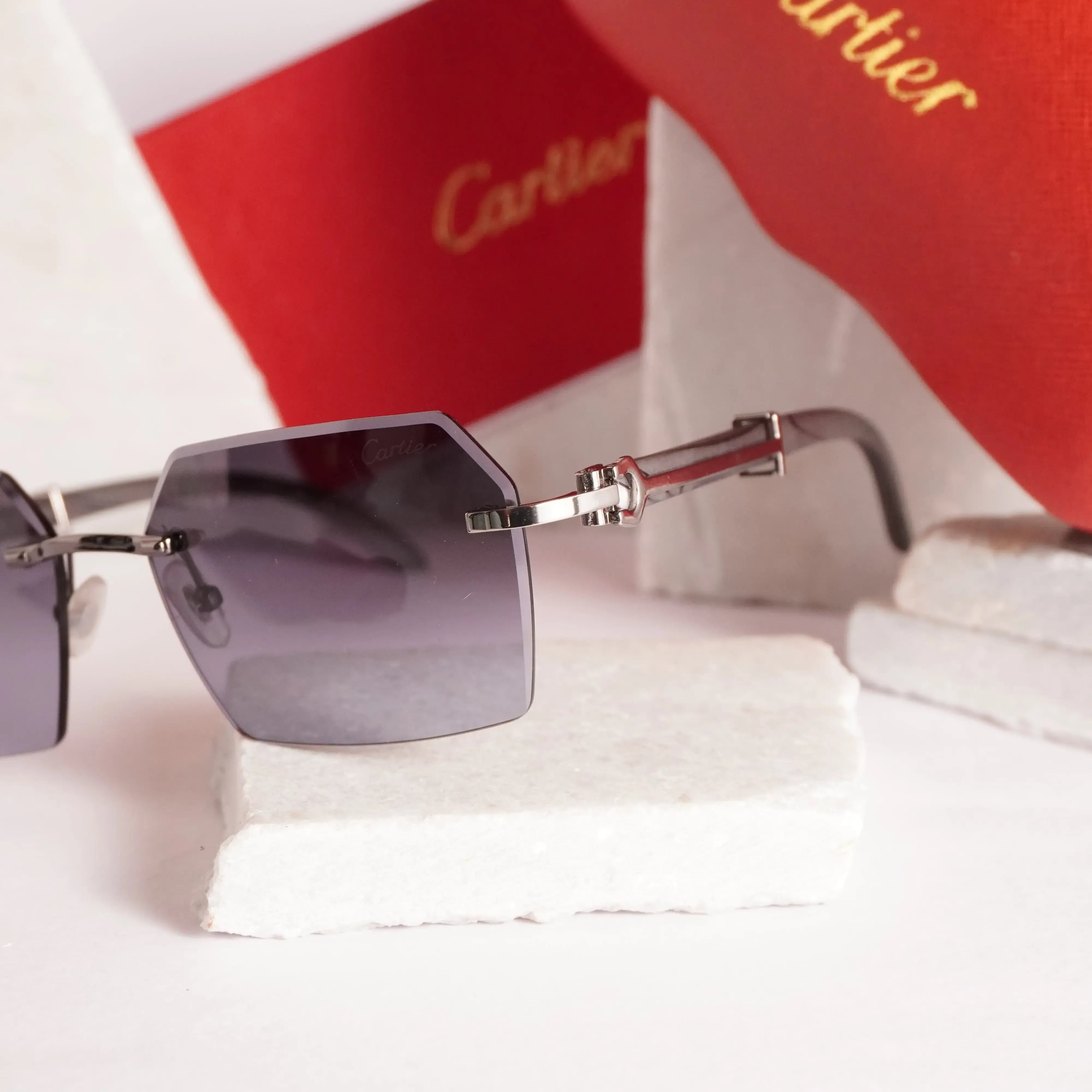 Rimless diamond-cut sunglasses - 3/4 angle view showing bevelled edges and double-bar hinges