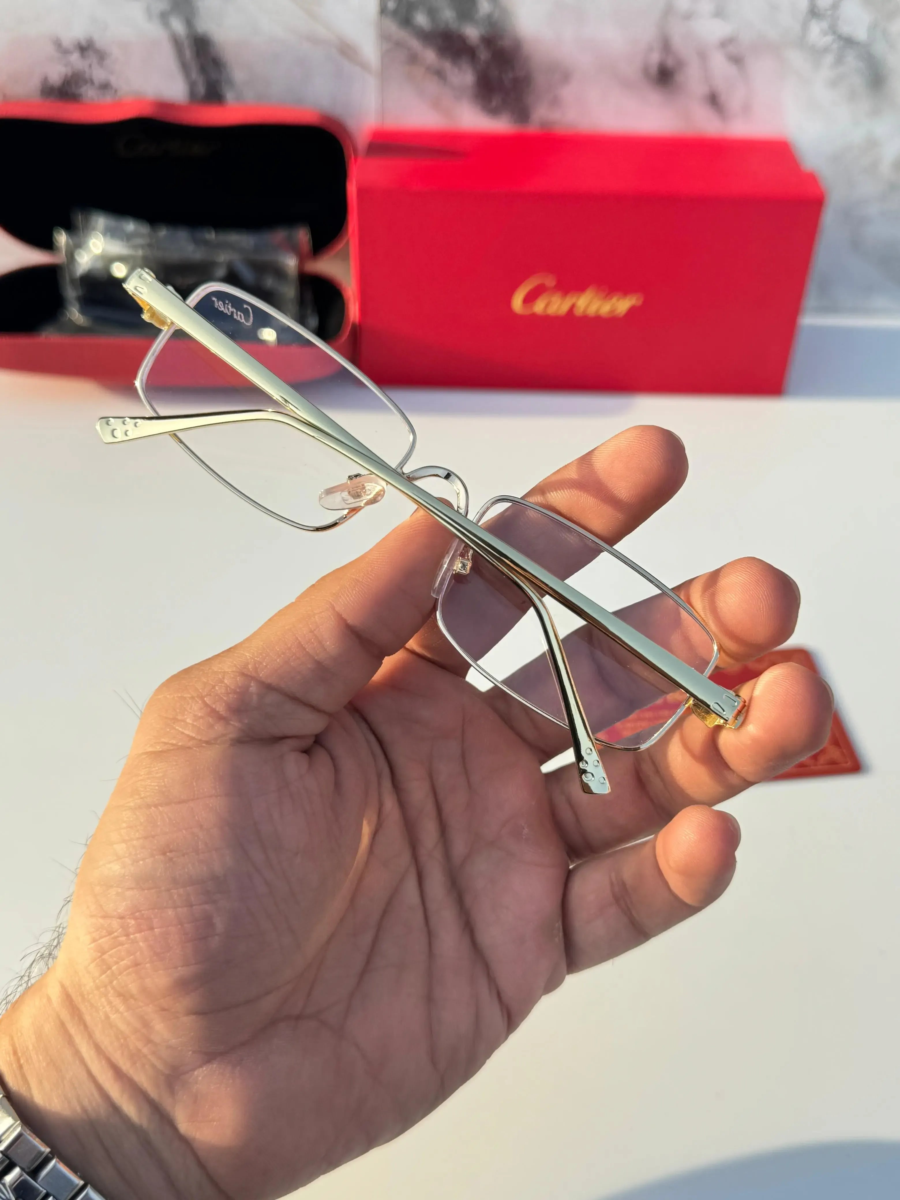 Gold rectangular eyeglasses - close up panther hinge detail