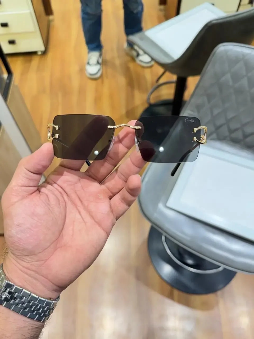 Rimless gold C-frame dual tone sunglasses - front palm view showing full frame with brown and dark grey lenses