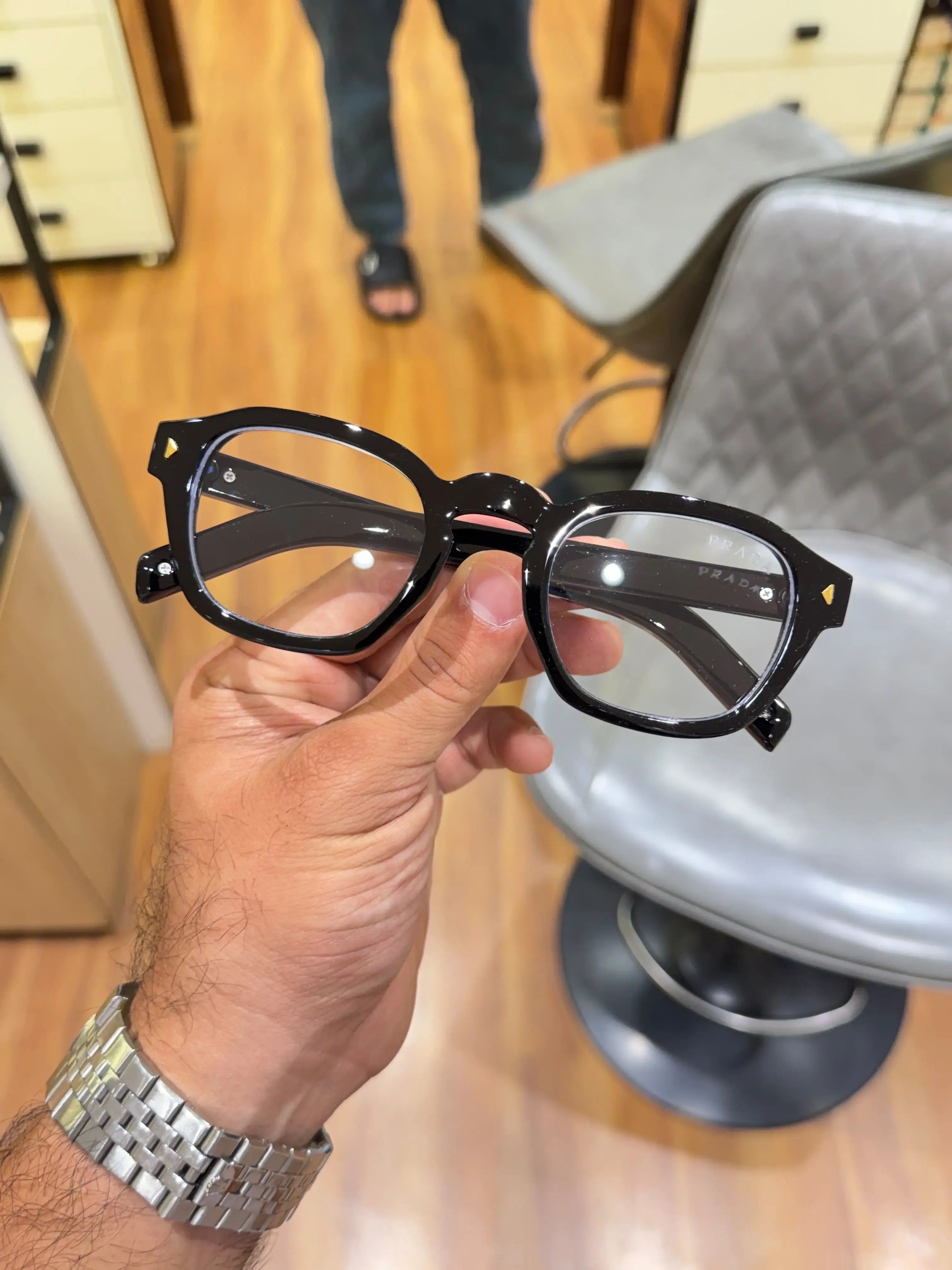 Prada Classic Black Gold Eyeglass Frame - Front View with Clear Lenses