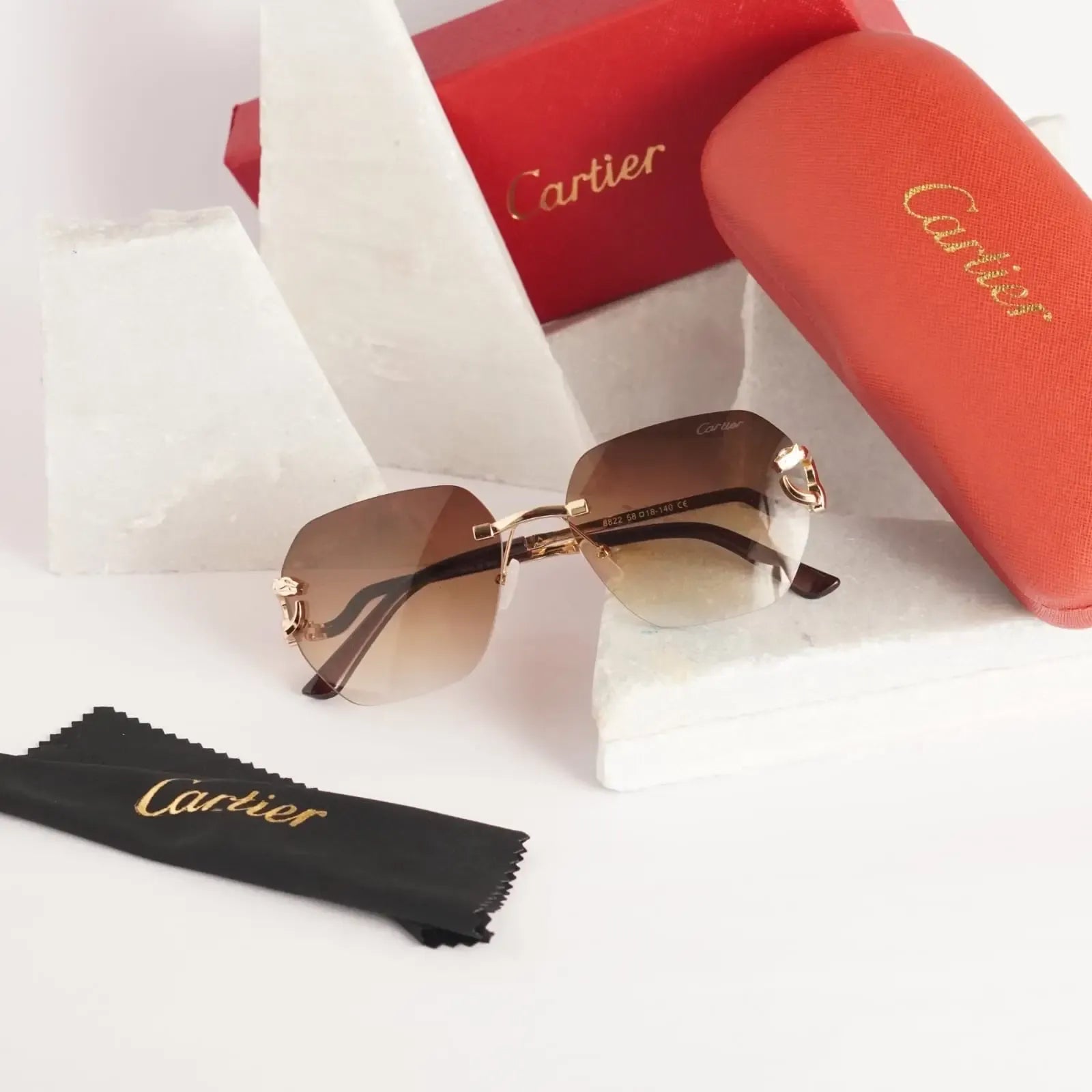 Rimless gold panther brown gradient sunglasses - side view with Cartier red case and box