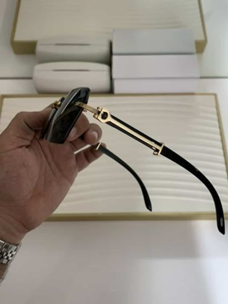 Dark smoke rimless square sunglasses - palm view showing gold bridge