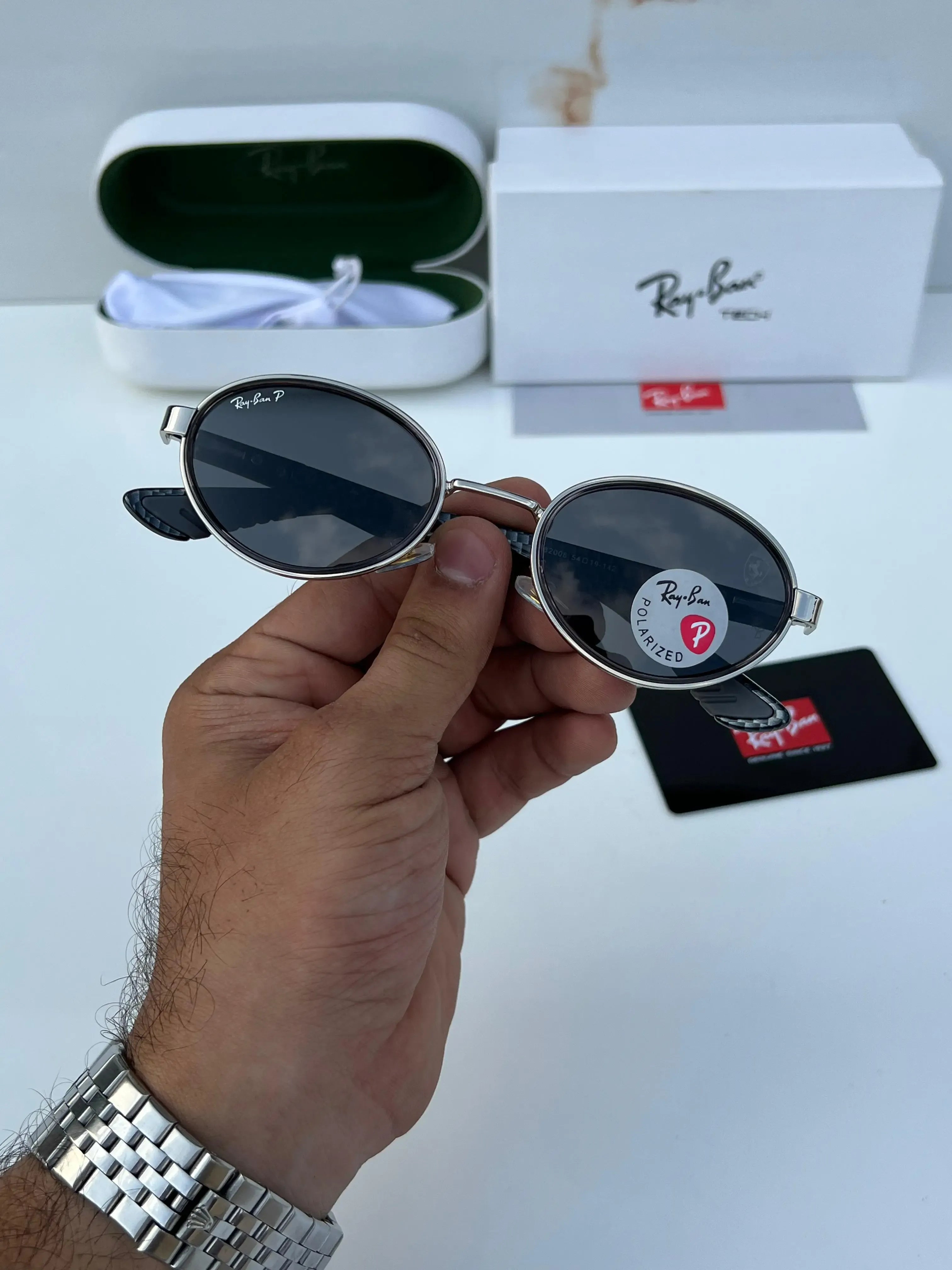 Ray-Ban x Ferrari RB8206 Silver Black - Display showing silver oval frame with carbon fibre temple arms and Ray-Ban Tech box