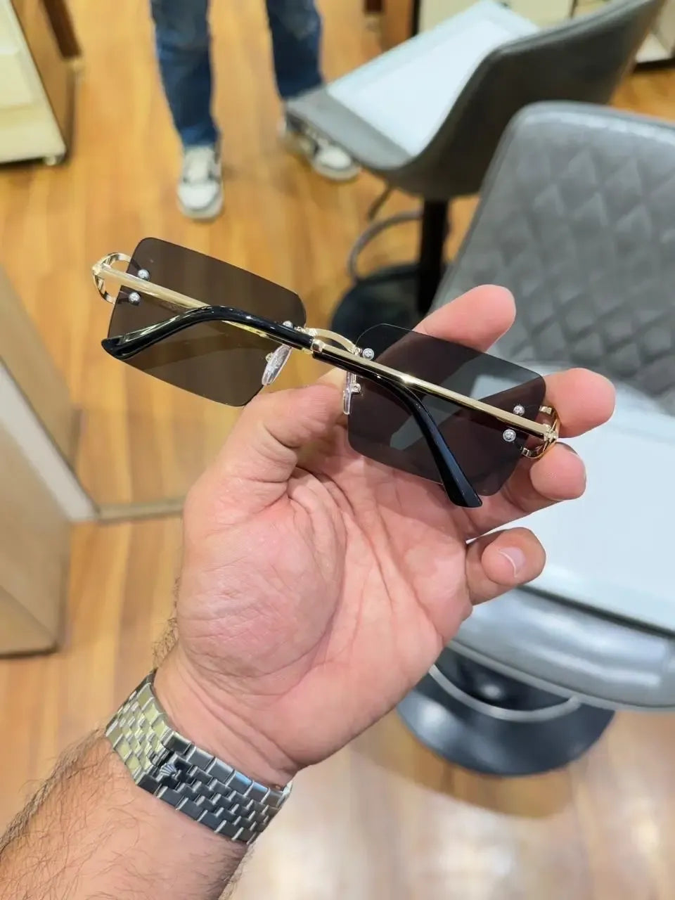 Rimless gold C-frame dual tone sunglasses - side profile showing slim gold temples with black tips and C-end piece