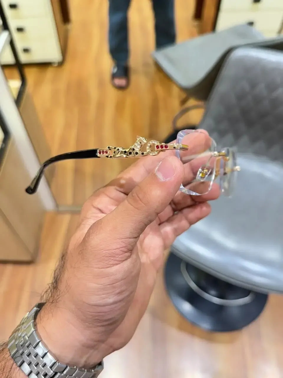 Rimless gold panther body bridge eyeglasses - angled view showing full frame with panther bridge and black temples