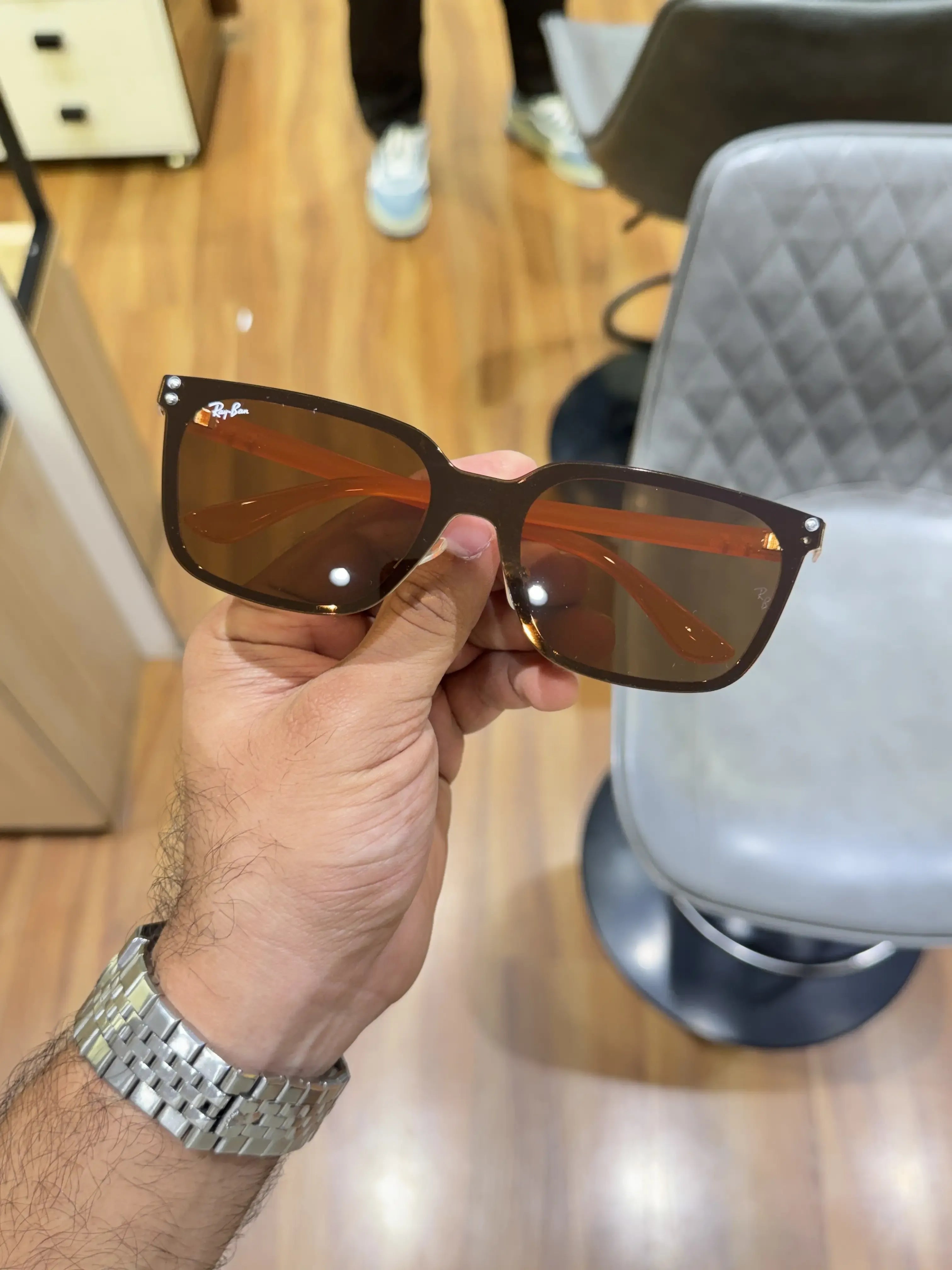 Ray-Ban RB2507S Orange Brown - Folded display showing orange temple arms and warm brown lenses with transparent nose pads