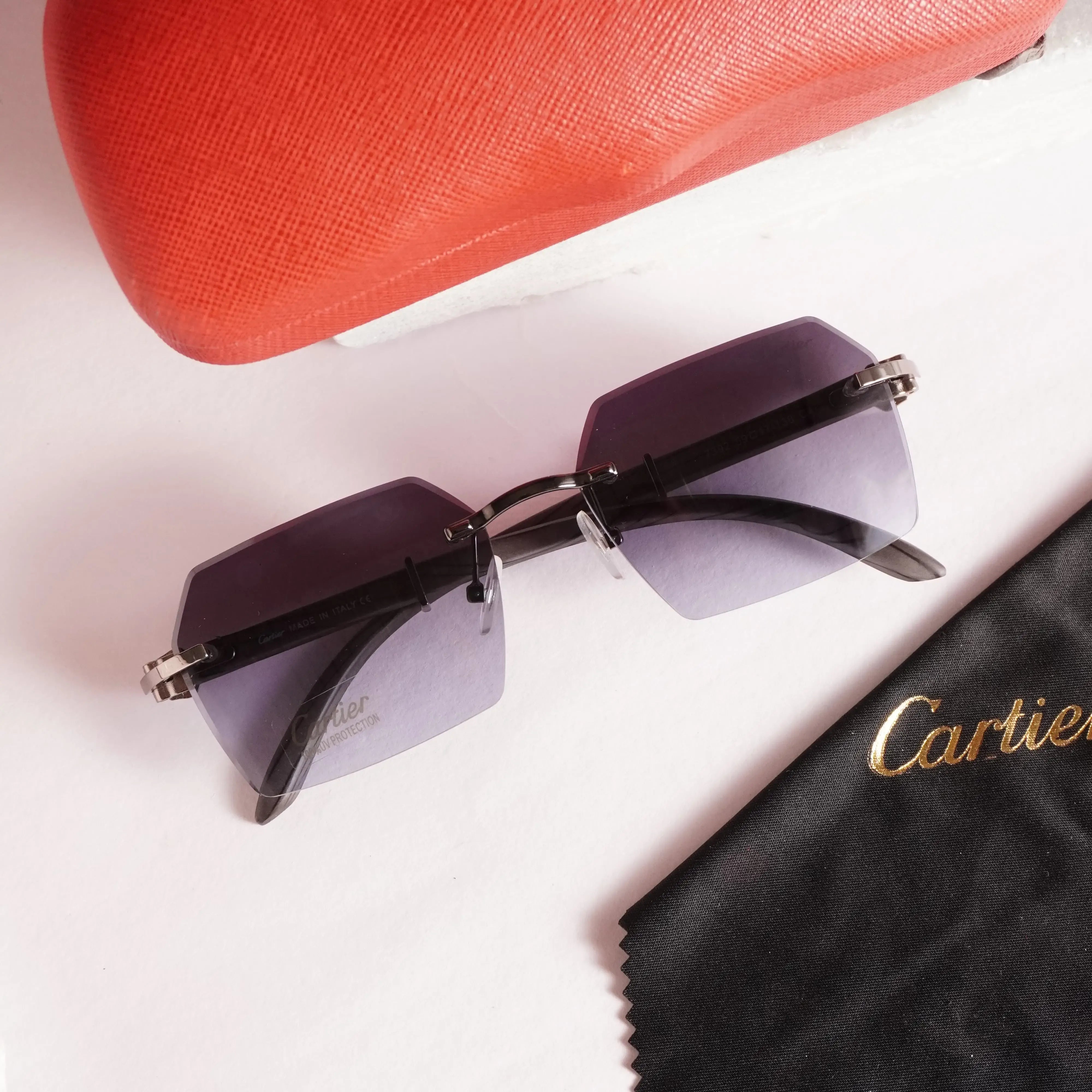 Rimless diamond-cut sunglasses - top flat lay view with Cartier cleaning cloth