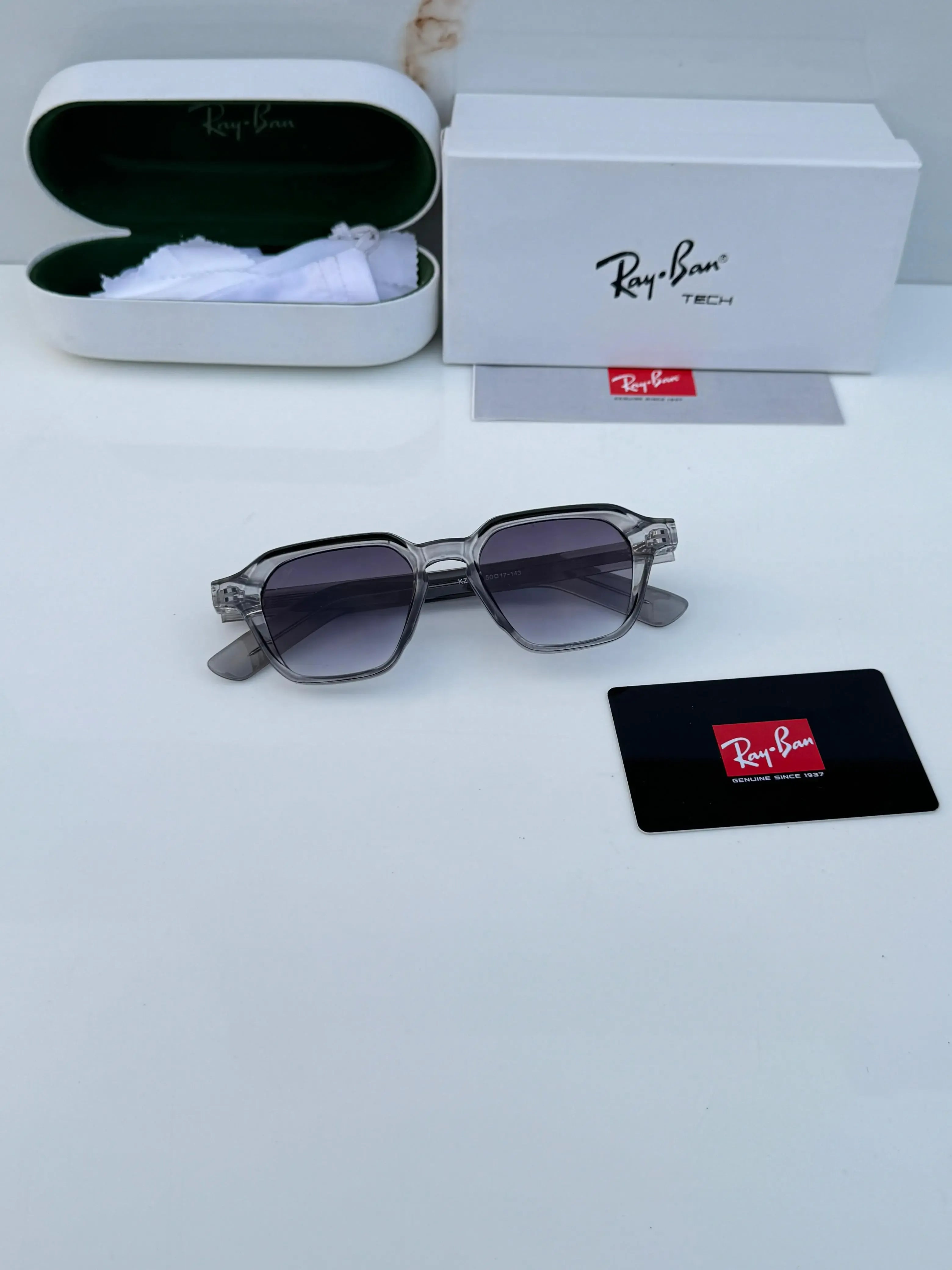 Ray-Ban RB1115 Grey Shaded - Hand holding frame showing transparent grey acetate and gradient lenses