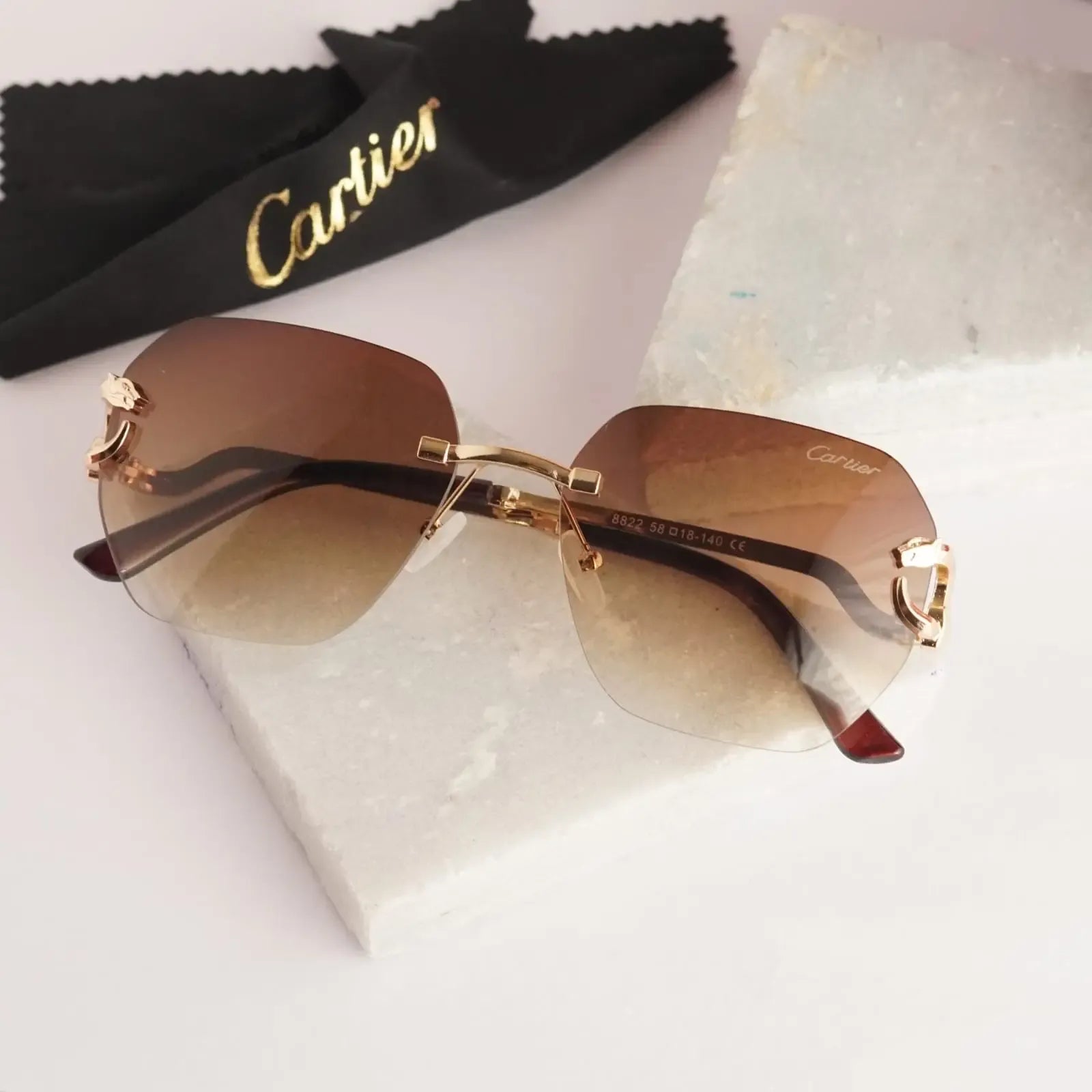Rimless gold panther brown gradient sunglasses - angled view showing honey gradient lens and bridge